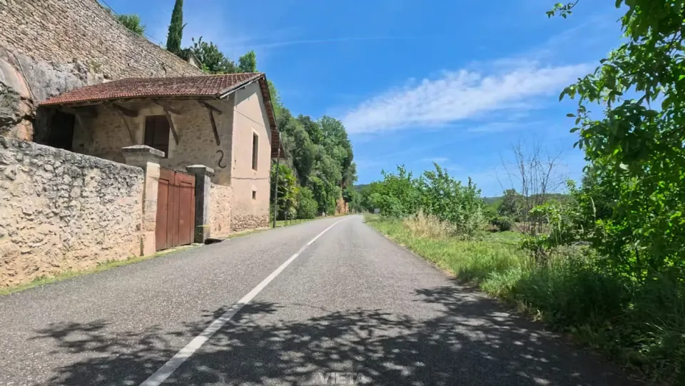 A quiet country road past an old stone house, filmed for the ride library